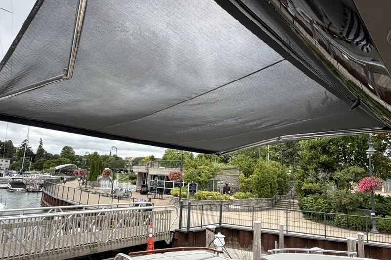 Slide: The Image of 2020 Princess S78 yacht with sunshade docked at a scenic marina. - 87