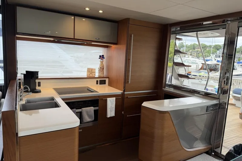 Slide: The Image of Luxurious 2020 Princess S78 yacht kitchen with modern appliances and sleek wood cabinetry. - 30