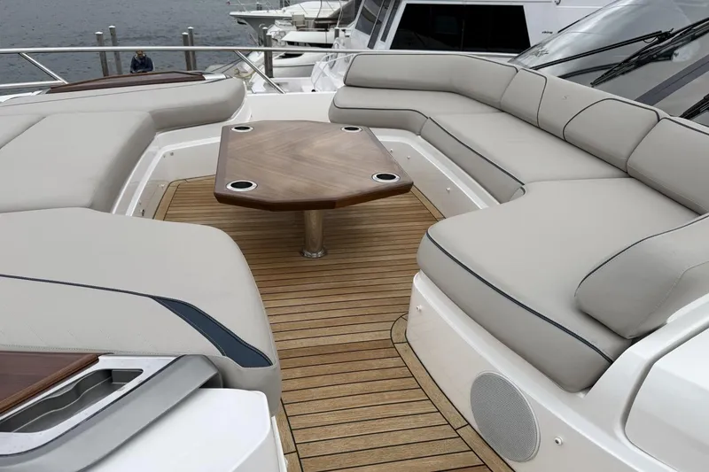 Slide: The Image of Luxurious seating area on 2020 Princess S78 yacht with wooden table and cushioned seats. - 81