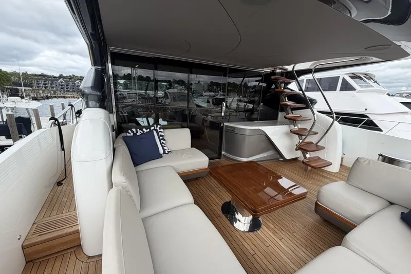 Slide: The Image of Luxurious 2020 Princess S78 yacht deck with elegant seating and wooden table. - 13