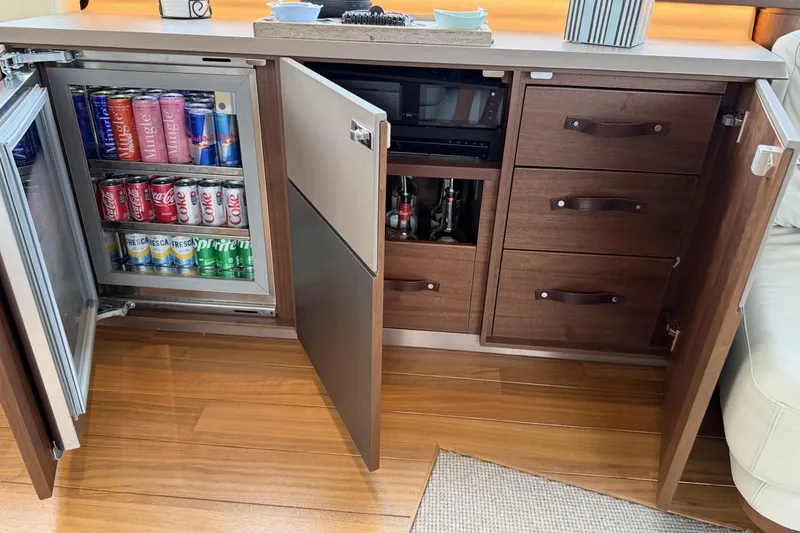 Slide: The Image of Luxury yacht interior with stocked mini-fridge and wooden cabinetry, Princess S78, 2020 model. - 44