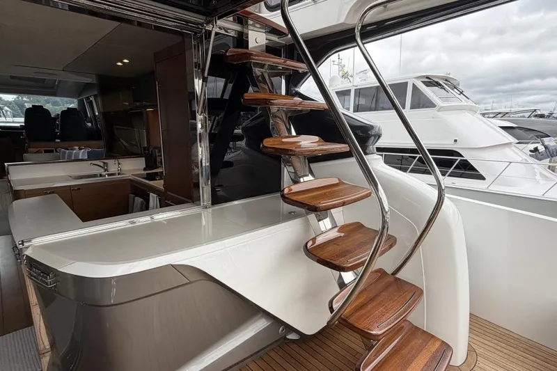 Slide: The Image of Luxurious 2020 Princess S78 yacht interior with elegant wooden staircase and modern kitchen area. - 86