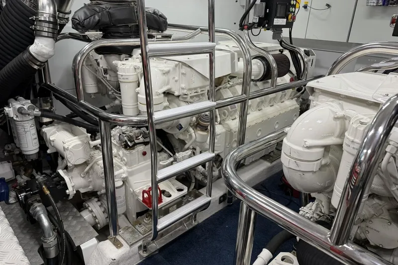 Slide: The Image of Engine room of a 2020 Princess S78 yacht, featuring dual white engines and chrome railings. - 90