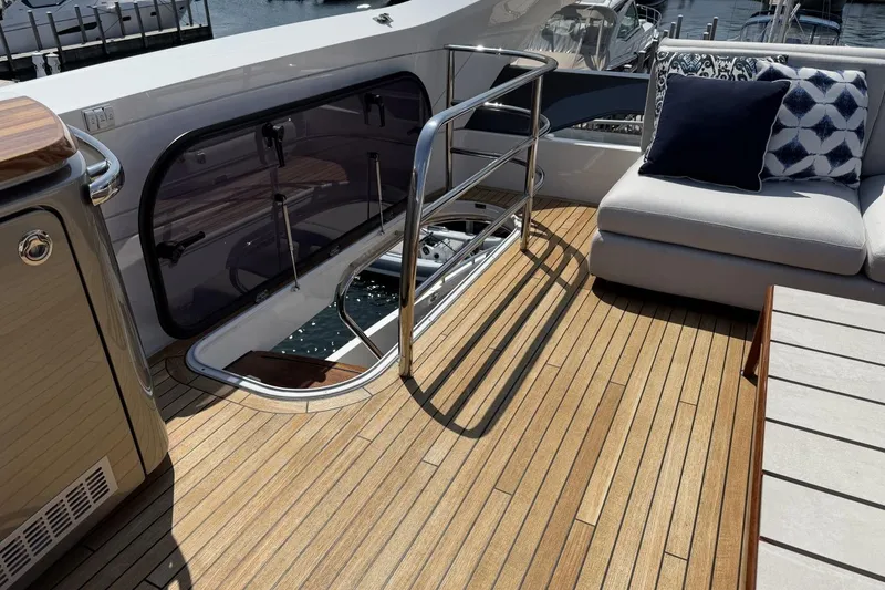 Slide: The Image of Luxurious 2020 Princess S78 yacht deck with elegant seating and polished wood flooring. - 78