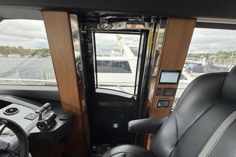 Slide: The Image of Interior view of a 2020 Princess S78 yacht cockpit with control panel and leather seating. - 48