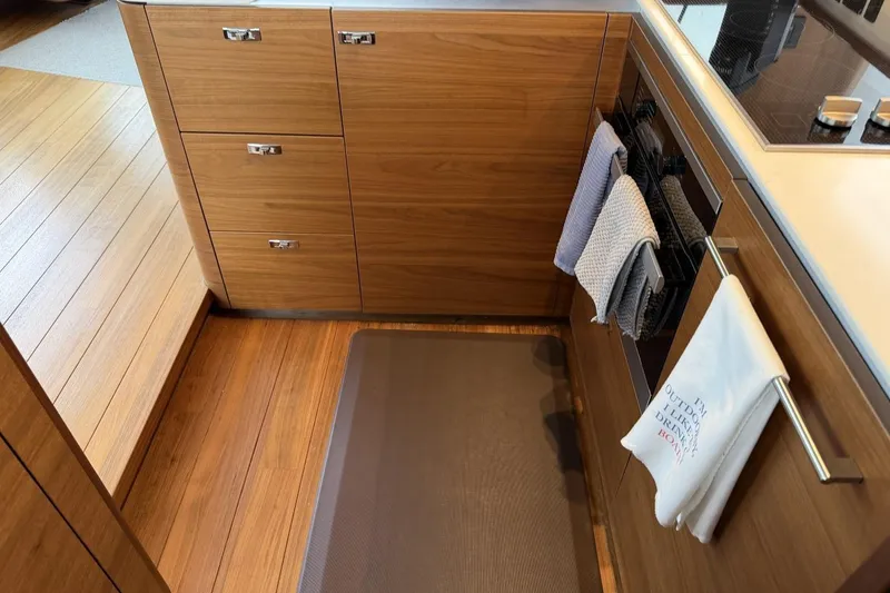 Slide: The Image of Modern kitchen interior on a 2020 Princess S78 yacht, featuring wooden cabinetry and sleek appliances. - 40