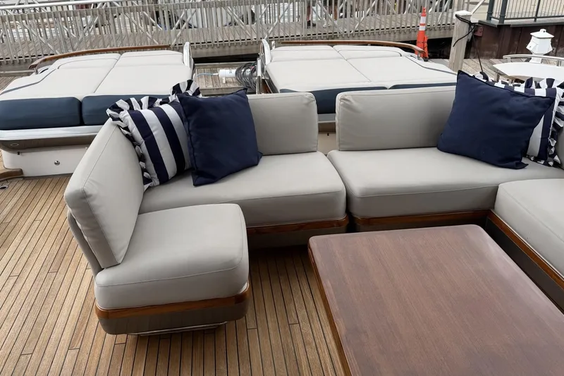 Slide: The Image of Luxurious seating area on 2020 Princess S78 yacht with striped cushions and wooden deck. - 18