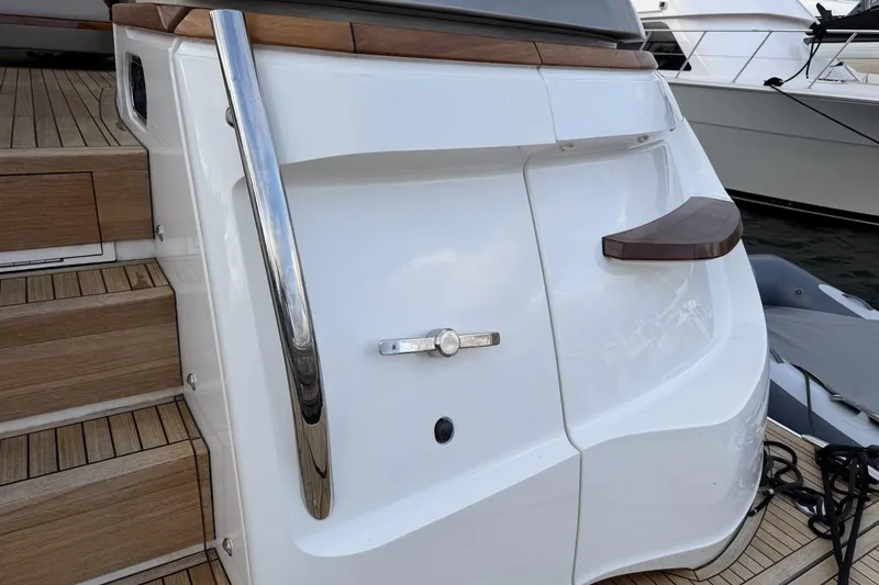 Slide: The Image of Sleek 2020 Princess S78 yacht with polished chrome railing and wooden deck details. - 100