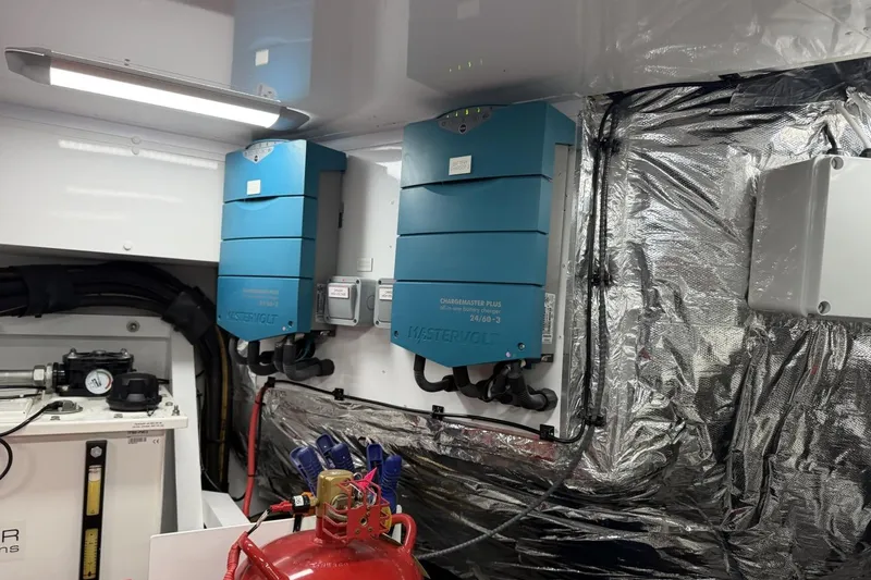 Slide: The Image of Electrical equipment inside a 2020 Princess S78 yacht, featuring Mastervolt chargers and wiring. - 98