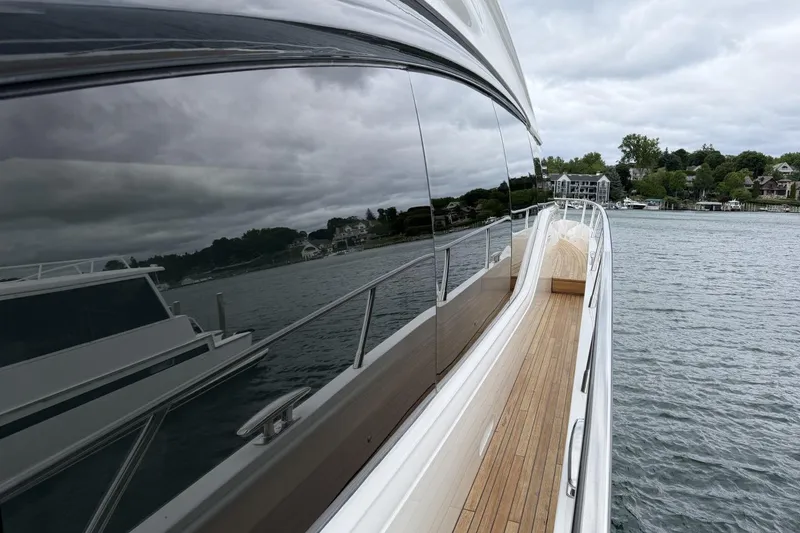 Slide: The Image of 2020 Princess S78 yacht with sleek design, docked near scenic shoreline. - 2