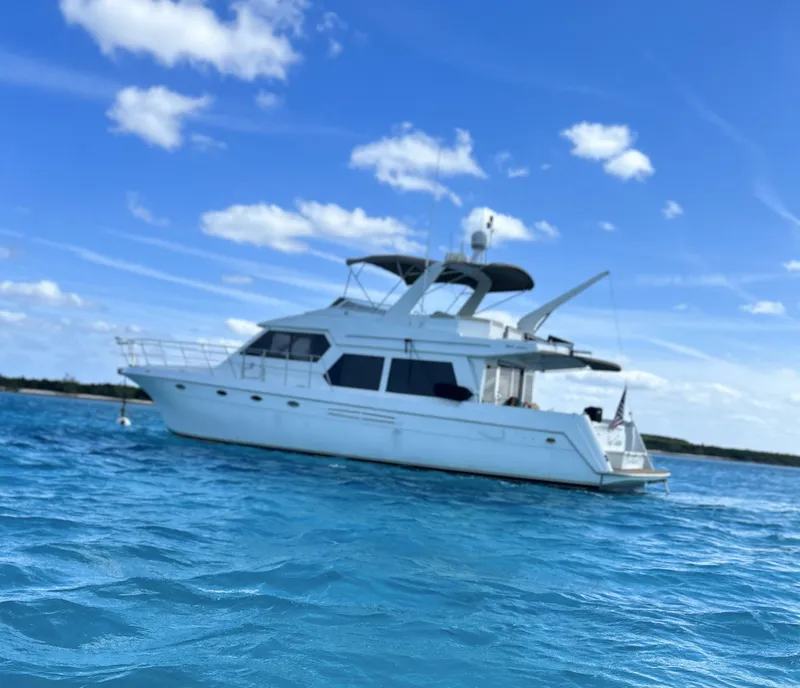 Slide: The Image of 2004 Navigator Rival yacht on clear blue water under a bright sky. - 0
