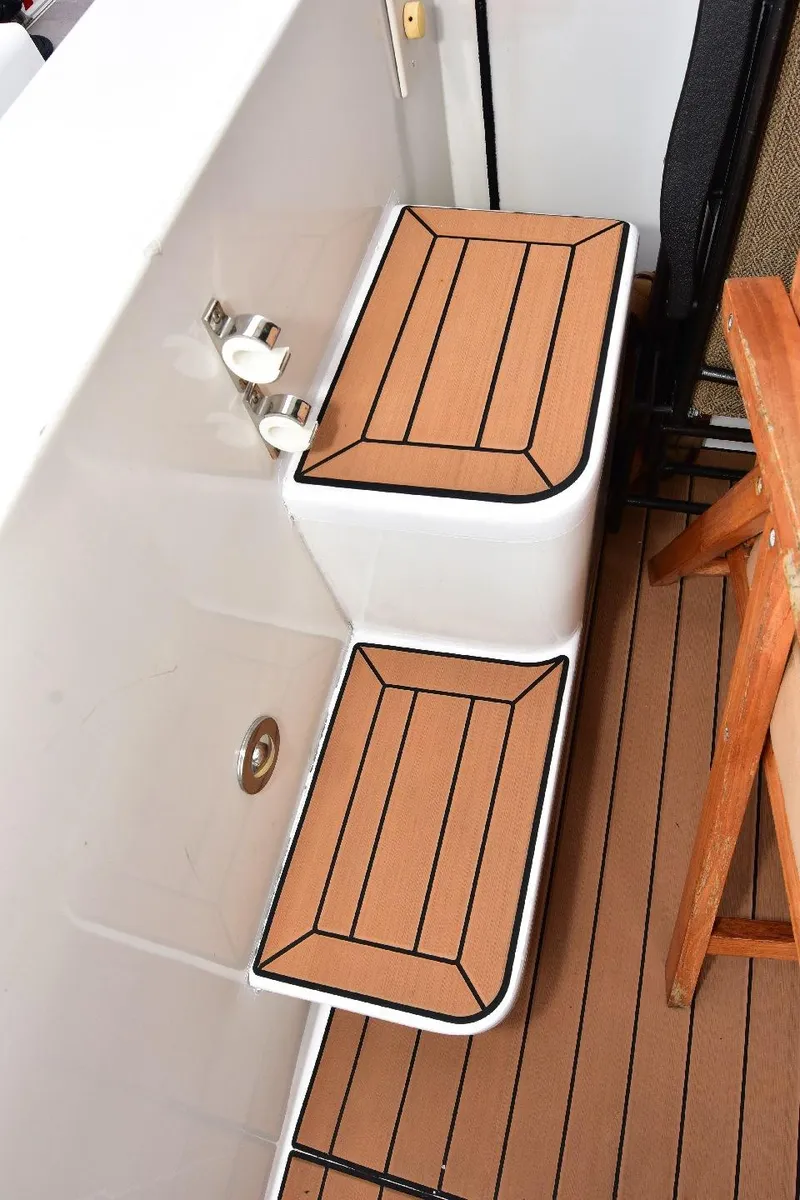 Slide: The Image of 2004 Navigator Rival boat steps with wood finish and non-slip surface. - 8
