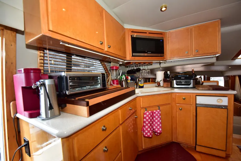 Slide: The Image of 2004 Navigator Rival kitchen with wooden cabinets, appliances, and cozy decor. - 42