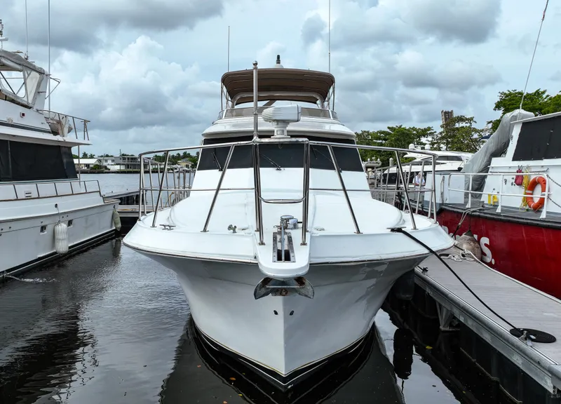 Slide: The Image of 2004 Navigator Rival yacht docked at marina under cloudy sky. - 1