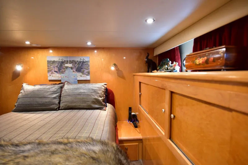Slide: The Image of Luxurious 2004 Navigator Rival yacht bedroom with cozy bedding and elegant wood cabinetry. - 27