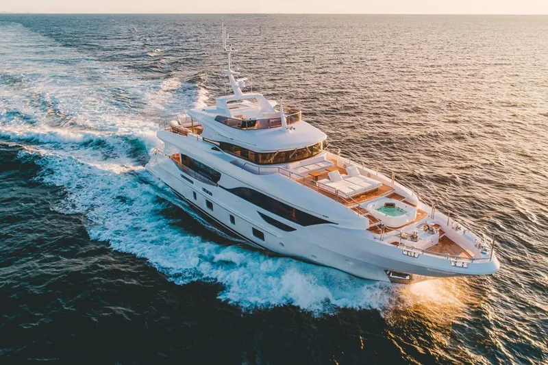Slide: The Image of Luxurious 2020 Benetti Delfino yacht cruising on open sea at sunset. - 0