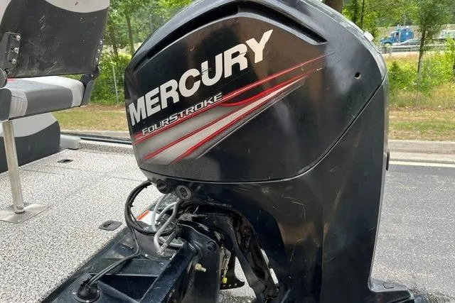 Slide: The Image of 2016 Tracker Pro Team 190 TX with Mercury FourStroke engine, parked outdoors. - 10