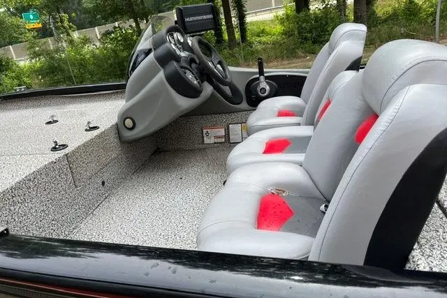 Slide: The Image of 2016 Tracker Pro Team 190 TX boat interior with gray and red seating. - 12