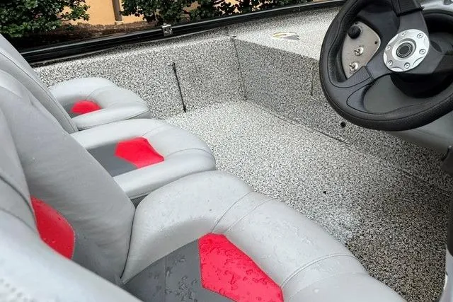 Slide: The Image of 2016 Tracker Pro Team 190 TX boat interior with gray and red seating. - 6