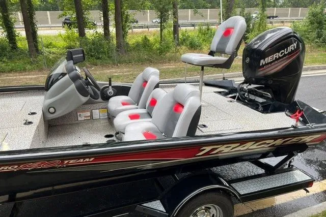Slide: The Image of 2016 Tracker Pro Team 190 TX fishing boat with Mercury engine, parked on a trailer. - 15
