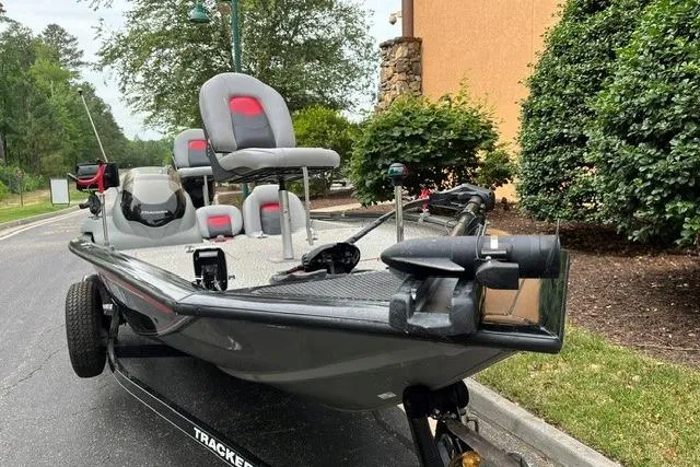 Slide: The Image of 2016 Tracker Pro Team 190 TX fishing boat on trailer, parked outdoors. - 2