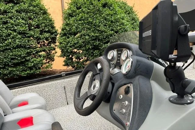 Slide: The Image of 2016 Tracker Pro Team 190 TX boat dashboard with steering wheel and gauges. - 5