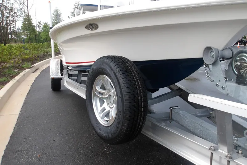 Slide: The Image of 2025 Mako 18 Pro Skiff Patriot Edition on trailer, showcasing sleek design and durable construction. - 6