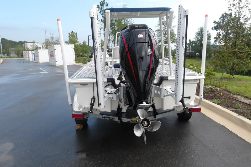 Slide: The Image of 2025 Mako 18 Pro Skiff Patriot Edition boat with powerful outboard motor. - 12