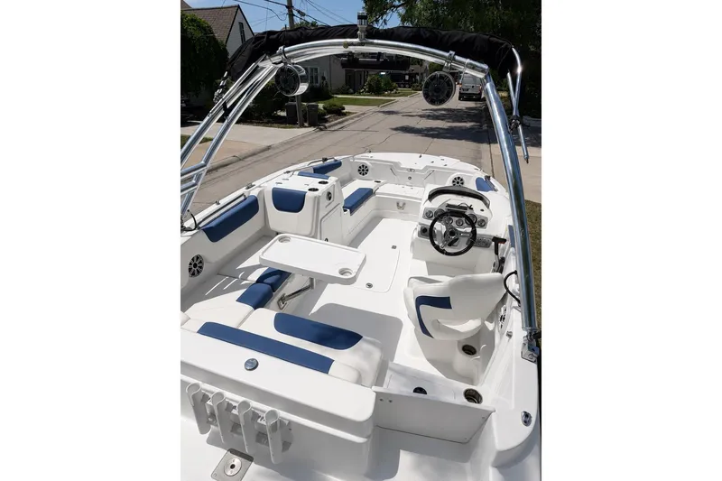 Slide: The Image of Interior of a 2019 Tahoe 1950 boat with blue and white seating. - 4