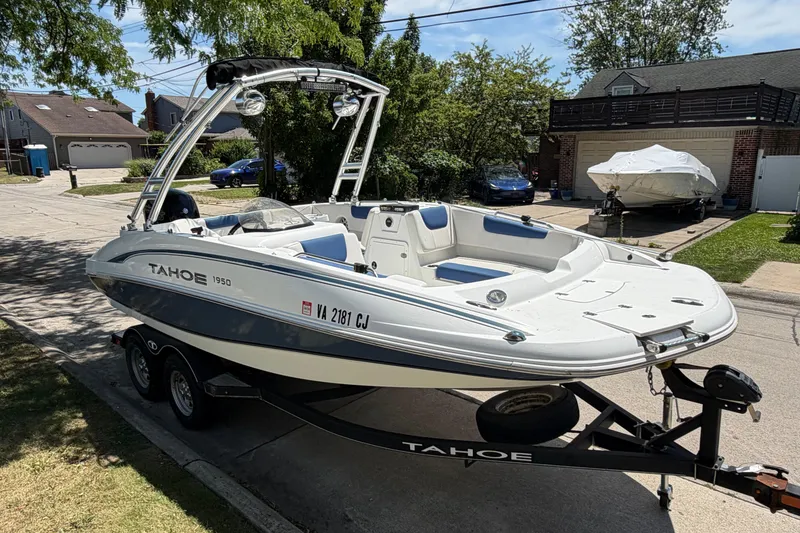 The Image of Tahoe 1950 boat on trailer, parked in residential area, 2019 model. - 0