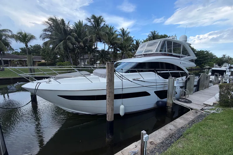 Slide: The Image of Luxury 2018 Princess F55 yacht docked by palm trees and clear sky. - 2