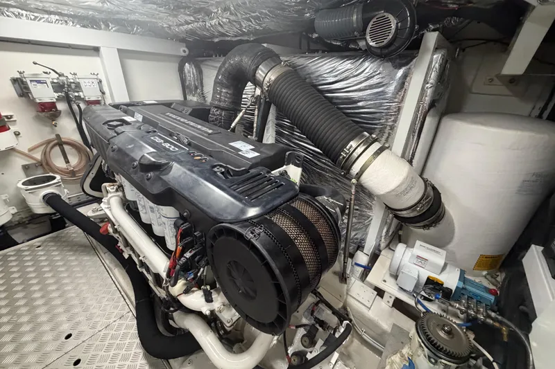 Slide: The Image of Engine room of a 2018 Princess F55 yacht, showcasing detailed mechanical components. - 33
