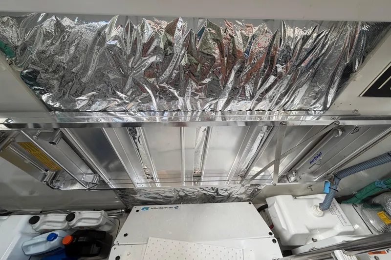 Slide: The Image of Engine room of a 2018 Princess F55 yacht with metallic insulation and equipment. - 34