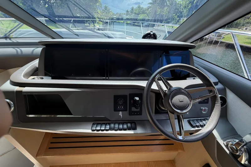 Slide: The Image of Cockpit of 2018 Princess F55 yacht with steering wheel and control panel. - 14