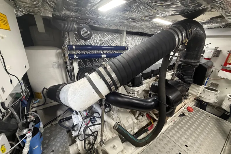Slide: The Image of Engine room of a 2018 Princess F55 yacht, showcasing complex machinery and piping. - 32