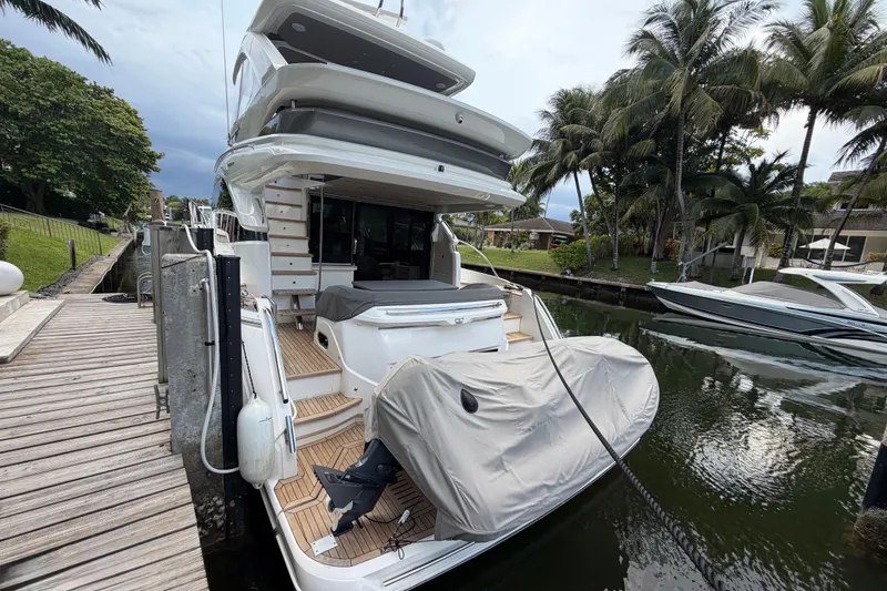 Slide: The Image of Luxury 2018 Princess F55 yacht docked by palm trees and wooden pier. - 3