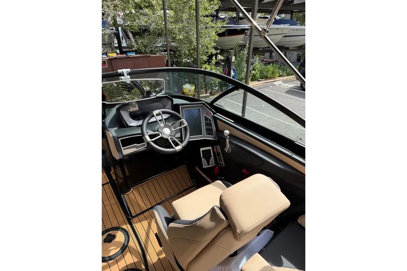 Slide: The Image of 2024 MasterCraft X24 boat interior with modern steering and dashboard controls. - 14