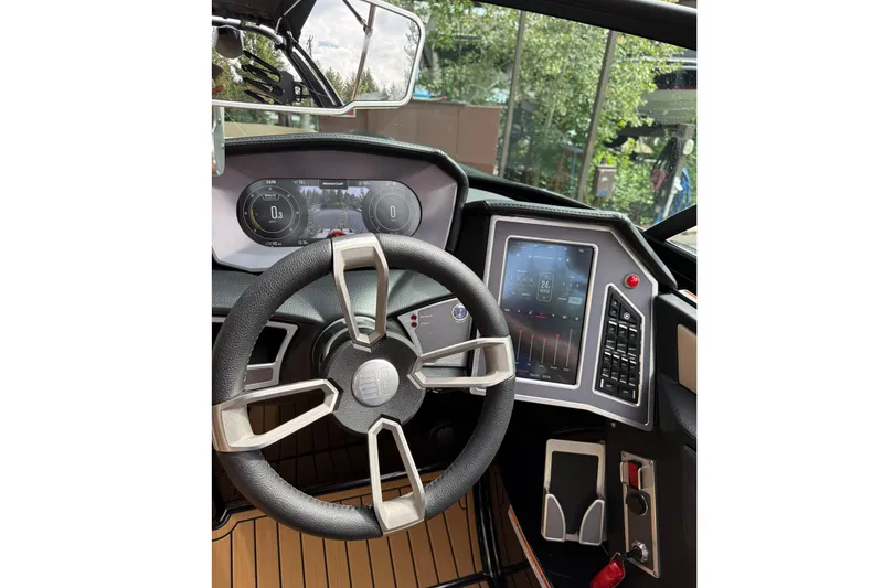 Slide: The Image of The image shows the cockpit of a 2024 MasterCraft X24 with a modern steering wheel and digital displays. - 15