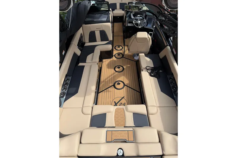 Slide: The Image of 2024 MasterCraft X24 boat interior with beige seating and sleek dashboard design. - 9