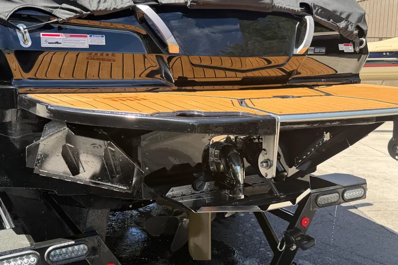 Slide: The Image of 2024 MasterCraft X24 boat stern with teak swim platform and propeller detail. - 6