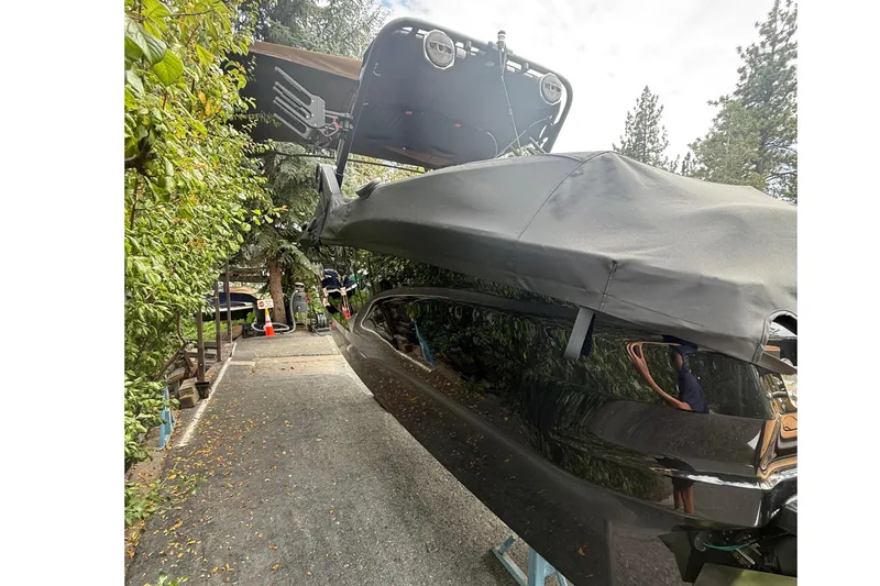 Slide: The Image of A 2024 MasterCraft X24 boat on a trailer, surrounded by trees. - 5