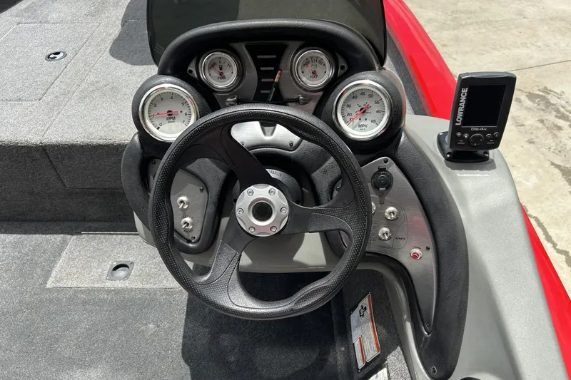 Slide: The Image of 2015 Tracker Pro Team 175 TXW boat dashboard with gauges and Lowrance Elite-4X fish finder. - 4