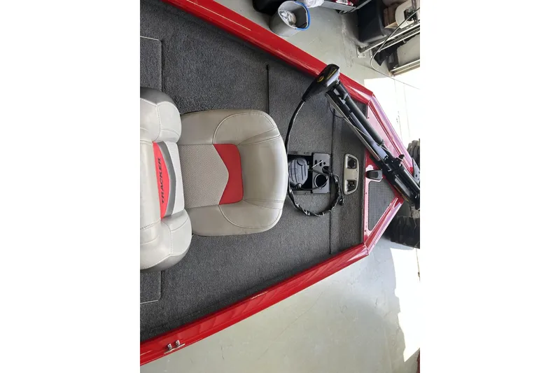 Slide: The Image of 2015 Tracker Pro Team 175 TXW boat interior with red accents and seating. - 5