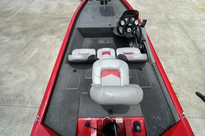 Slide: The Image of 2015 Tracker Pro Team 175 TXW boat interior with gray and red seating. - 3