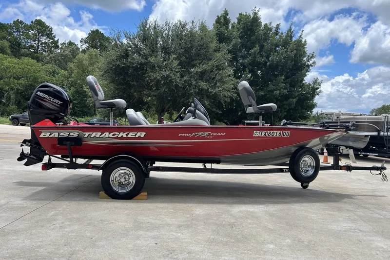 Slide: The Image of 2015 Tracker Pro Team 175 TXW bass boat on trailer, parked outdoors. - 10