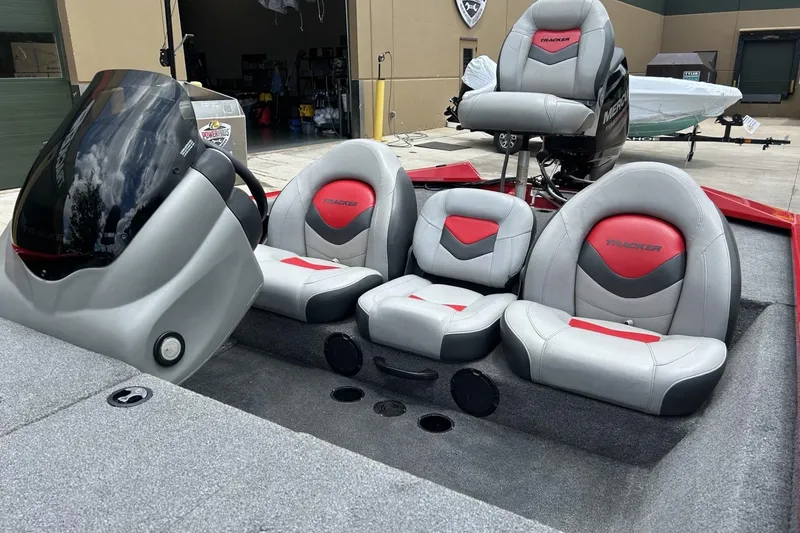 Slide: The Image of 2015 Tracker Pro Team 175 TXW boat interior with gray and red seating. - 13