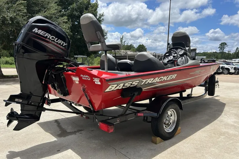 Slide: The Image of 2015 Tracker Pro Team 175 TXW bass boat with Mercury engine on trailer. - 9