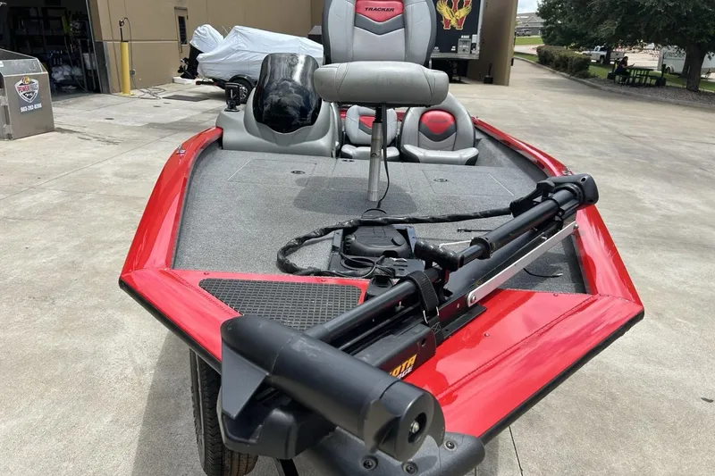 Slide: The Image of 2015 Tracker Pro Team 175 TXW boat with red exterior and fishing equipment. - 12