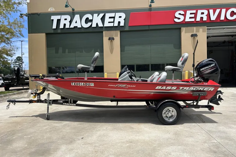 The Image of 2015 Tracker Pro Team 175 TXW bass boat on trailer outside service center. - 1