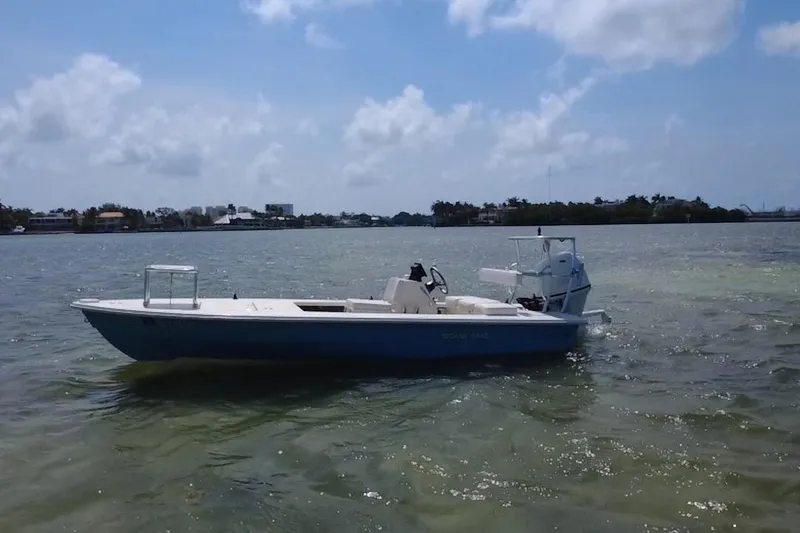 Slide: The Image of 2013 Hell's Bay Biscayne boat on calm waters under a partly cloudy sky. - 1